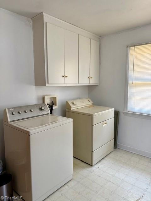 washroom with cabinets and independent washer and dryer