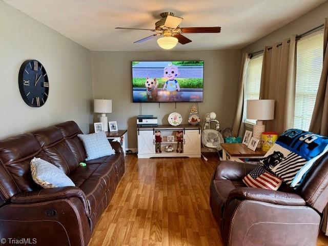 living room with hardwood / wood-style floors and ceiling fan