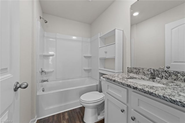 full bathroom with vanity, tub / shower combination, hardwood / wood-style floors, and toilet