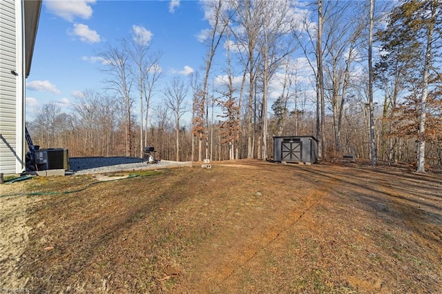 view of yard with a shed and central AC