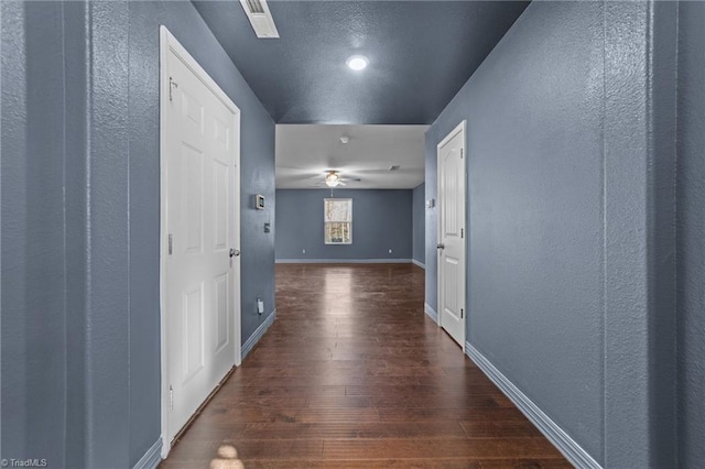 corridor with dark wood-type flooring