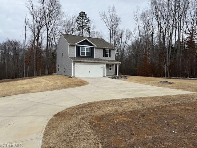 view of front facade with a garage and a front lawn