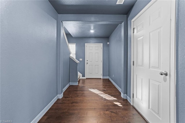 entryway with dark hardwood / wood-style flooring