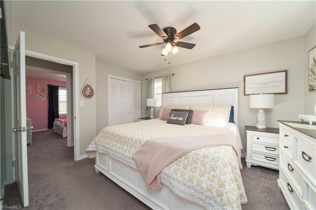 bedroom featuring ceiling fan, a closet, and dark carpet