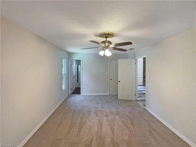6630 Riverwood Rd, Walkertown, NC 27051 - unfurnished bedroom with carpet, a textured ceiling, a closet, ceiling fan, and ensuite bathroom