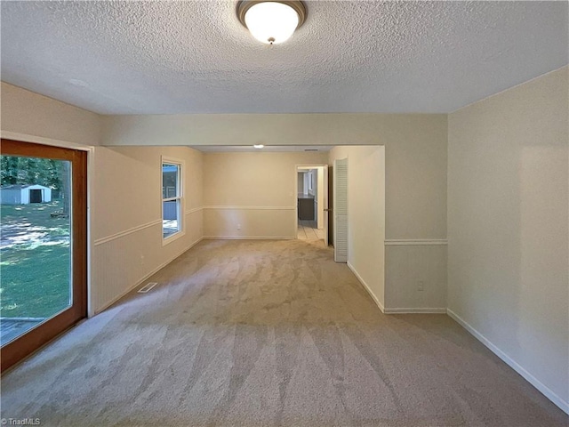 6630 Riverwood Rd, Walkertown, NC 27051 - carpeted spare room featuring a textured ceiling and baseboards
