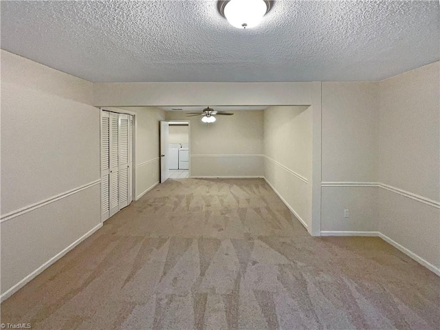 6630 Riverwood Rd, Walkertown, NC 27051 - unfurnished room with carpet flooring, a textured ceiling, a ceiling fan, and washing machine and clothes dryer