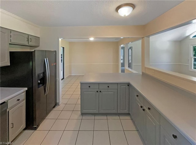 6630 Riverwood Rd, Walkertown, NC 27051 - kitchen with refrigerator with ice dispenser, light tile patterned floors, light countertops, gray cabinets, and a textured ceiling