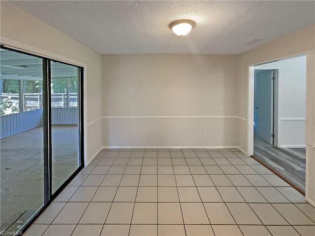 6630 Riverwood Rd, Walkertown, NC 27051 - spare room featuring a textured ceiling and light tile patterned floors