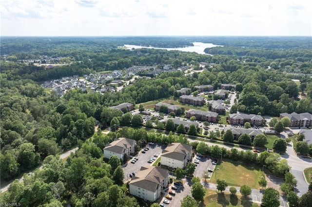 aerial view featuring a residential view and a wooded view