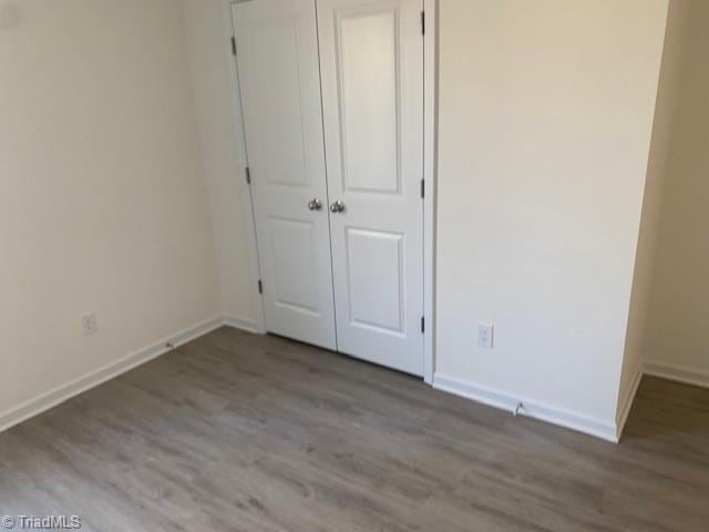 unfurnished bedroom featuring light hardwood / wood-style floors and a closet