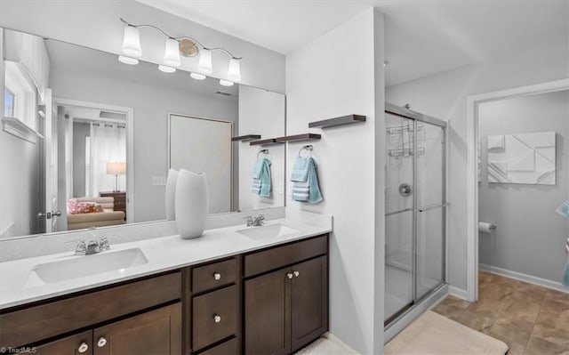 bathroom featuring an enclosed shower and vanity