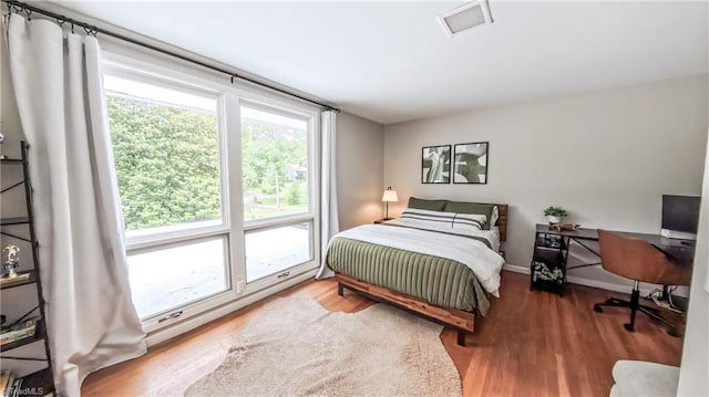 3307 Gaston Rd, Greensboro, NC 27407 - bedroom with multiple windows, wood finished floors, and a desk