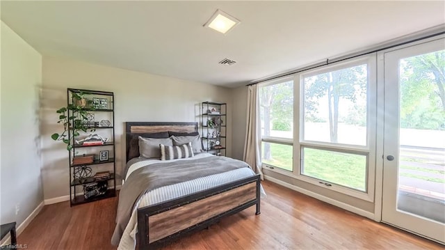 3307 Gaston Rd, Greensboro, NC 27407 - bedroom with wood finished floors, baseboards, and access to outside