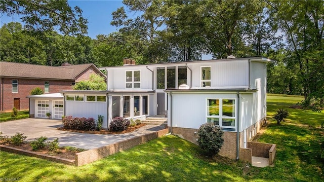 3307 Gaston Rd, Greensboro, NC 27407 - view of front of house with a garage, concrete driveway, and a front yard
