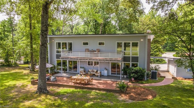 3307 Gaston Rd, Greensboro, NC 27407 - back of house featuring a balcony, a patio area, a lawn, and central air condition unit