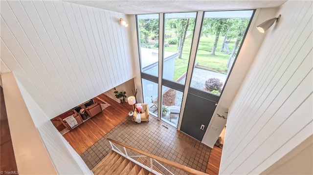 3307 Gaston Rd, Greensboro, NC 27407 - living area with a wall of windows, wood walls, healthy amount of natural light, and a textured ceiling