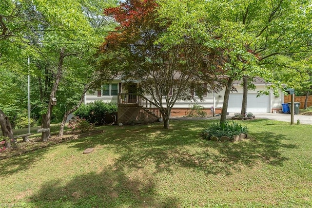 view of yard with a garage and driveway