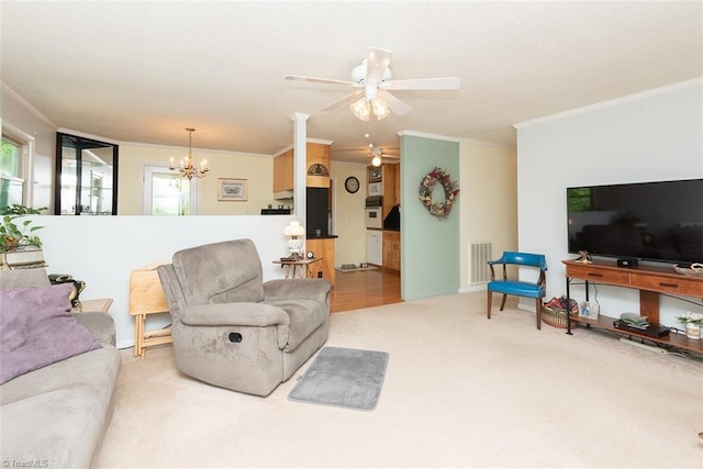 carpeted living room featuring crown molding, ceiling fan with notable chandelier, a wealth of natural light, and visible vents