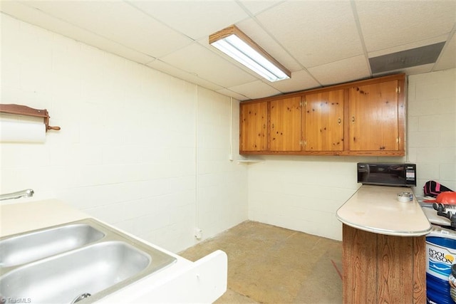 washroom with concrete block wall
