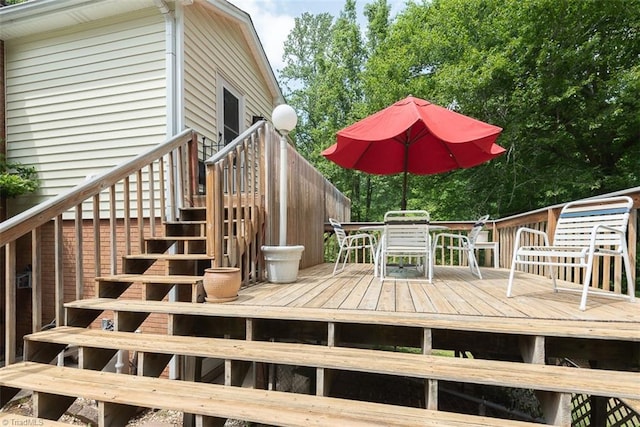 deck featuring stairway and outdoor dining area