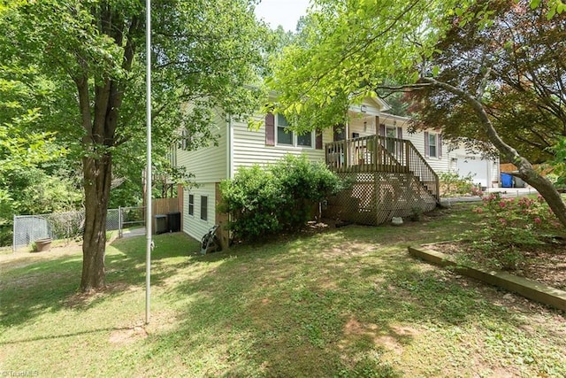 view of yard featuring a garage and fence