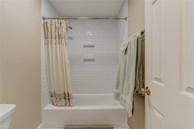 bathroom with toilet and shower / tub combo