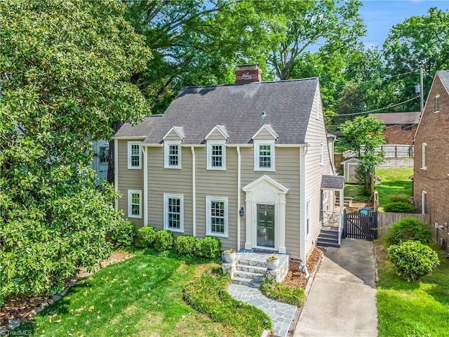 1109 Greenway Dr, High Point, NC 27262 - colonial house featuring a chimney, fence, and a shingled roof