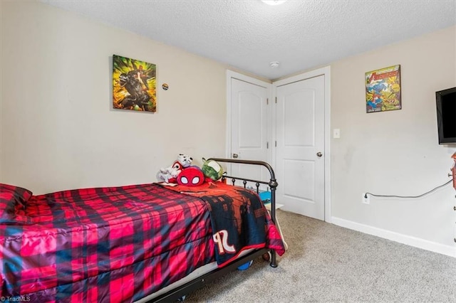 bedroom featuring carpet flooring and a textured ceiling