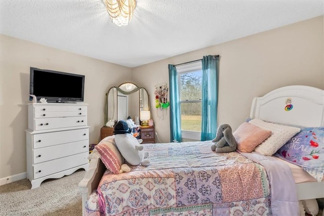 bedroom with carpet floors and a textured ceiling