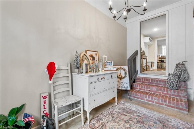 interior space with a chandelier and concrete floors