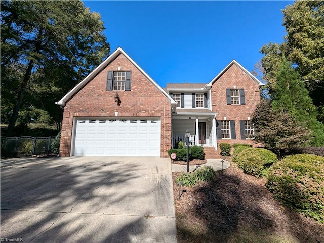 view of front property featuring covered porch and a garage