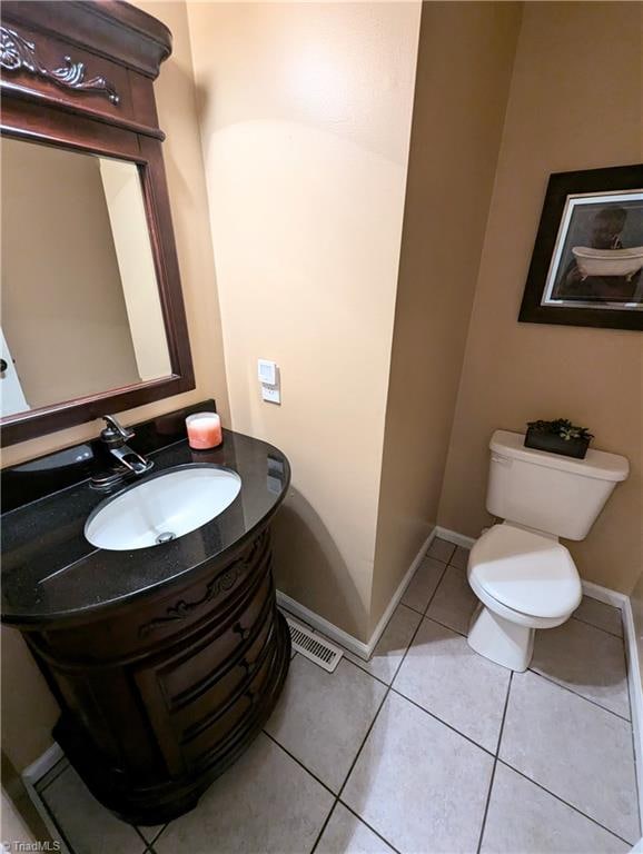 bathroom with tile patterned flooring, vanity, and toilet