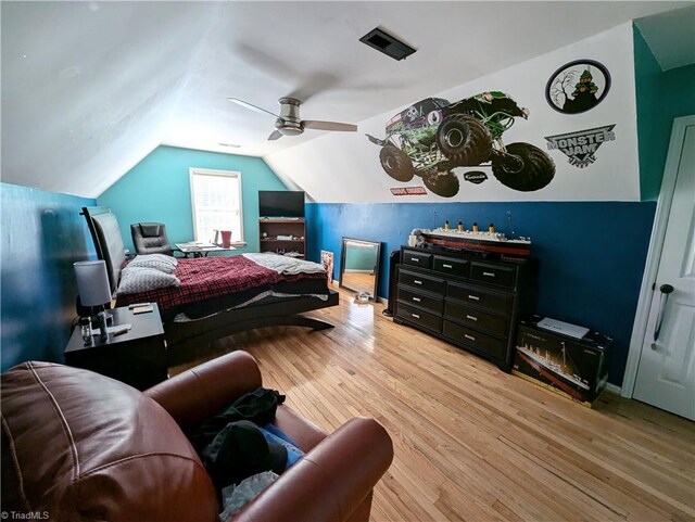 bedroom with lofted ceiling, hardwood / wood-style flooring, and ceiling fan