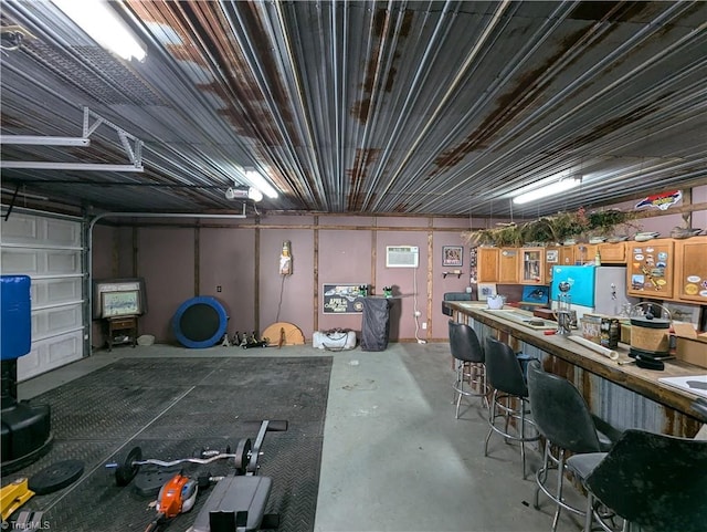 basement featuring a workshop area and a wall unit AC