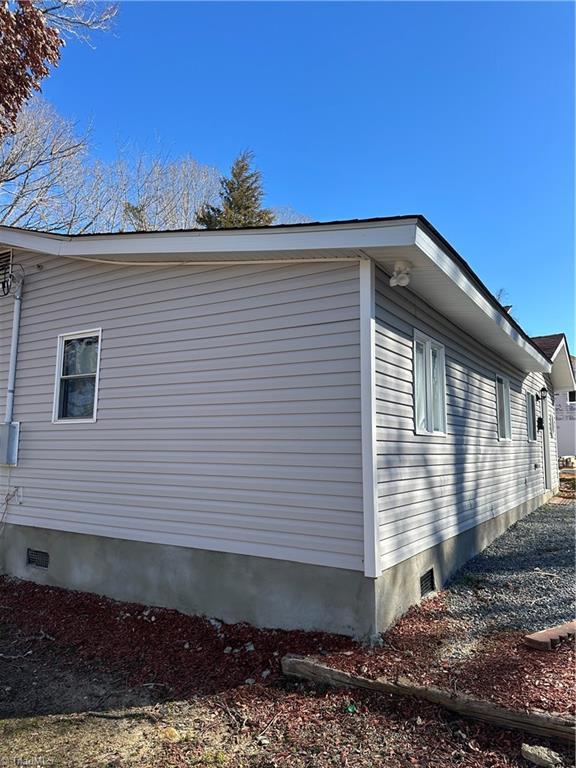 view of side of property featuring crawl space