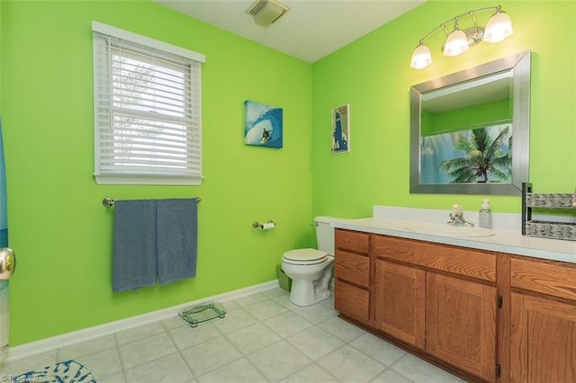 bathroom featuring tile patterned flooring, vanity, and toilet