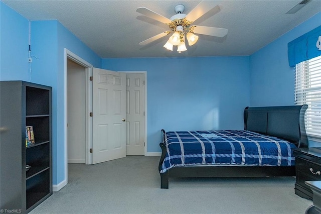 bedroom featuring carpet, a textured ceiling, and ceiling fan