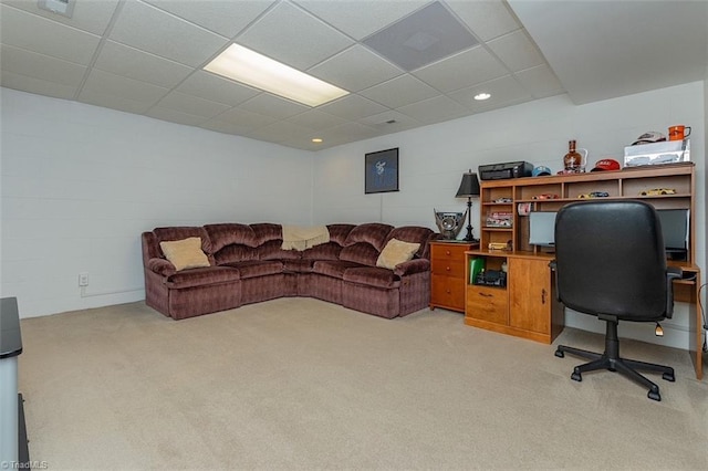 carpeted home office featuring a drop ceiling