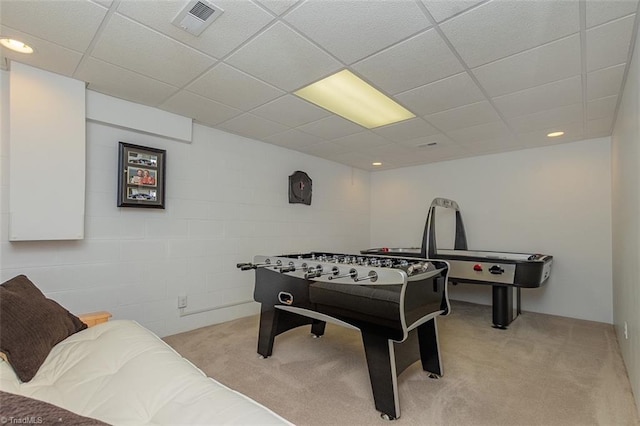 recreation room with a drop ceiling and light colored carpet