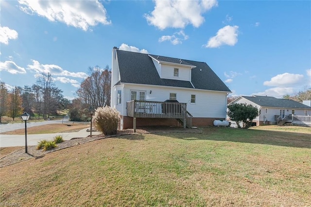 back of house with a lawn and a deck