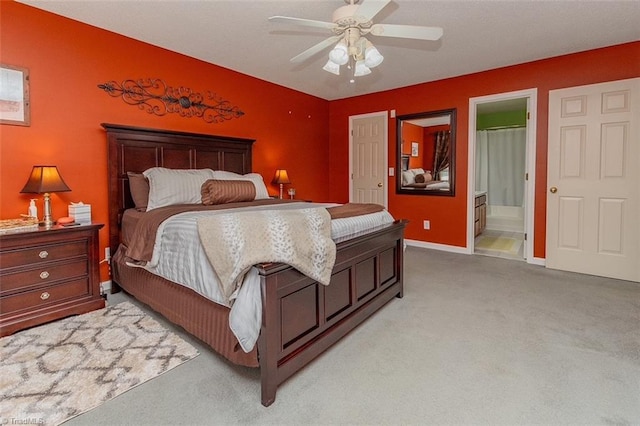 carpeted bedroom featuring ensuite bathroom and ceiling fan