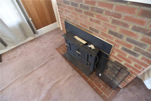 interior details featuring carpet flooring and a wood stove