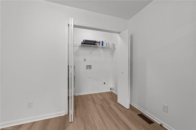 laundry room featuring baseboards, visible vents, washer hookup, wood finished floors, and laundry area