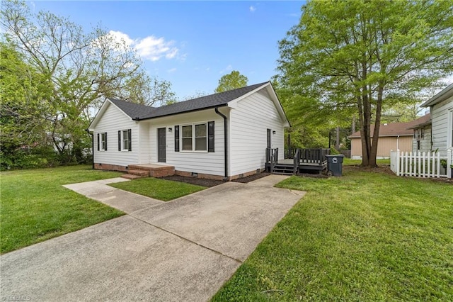 view of front of house with driveway, fence, a deck, crawl space, and a front yard