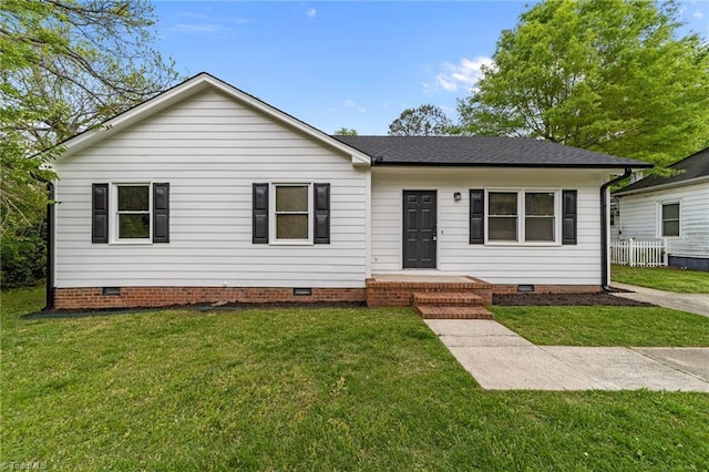 ranch-style home with crawl space, roof with shingles, and a front yard