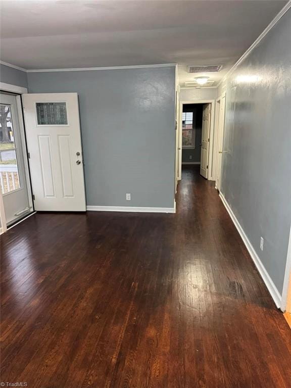 spare room with dark hardwood / wood-style flooring and ornamental molding