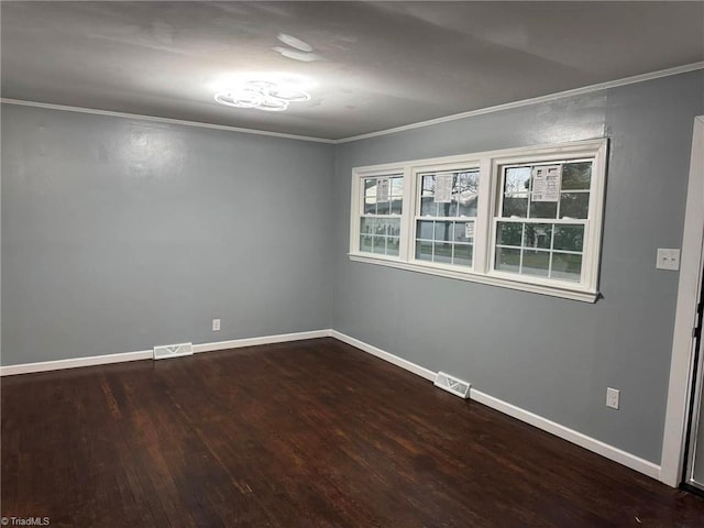 spare room with crown molding and wood-type flooring