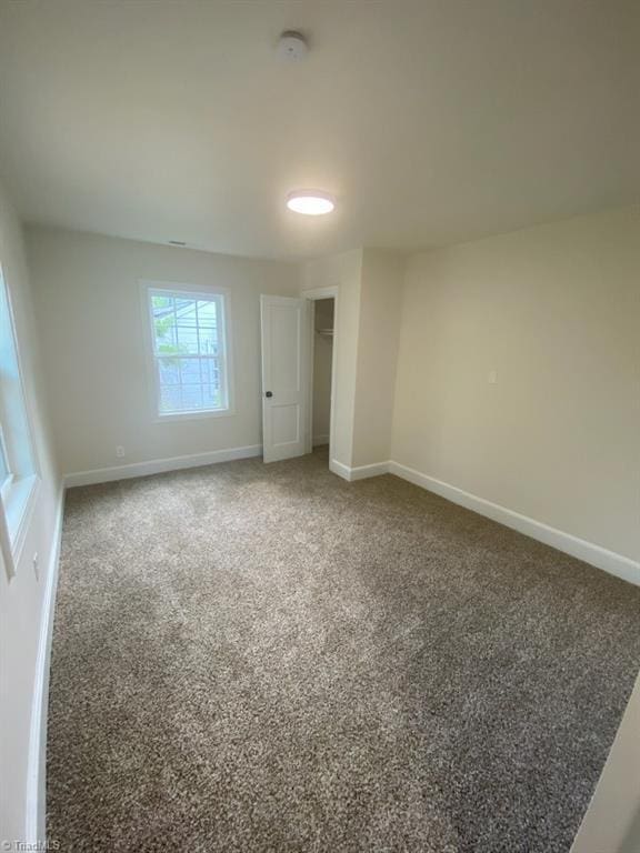 820 Broad Ave, Greensboro, NC 27406 - unfurnished bedroom featuring baseboards and carpet floors