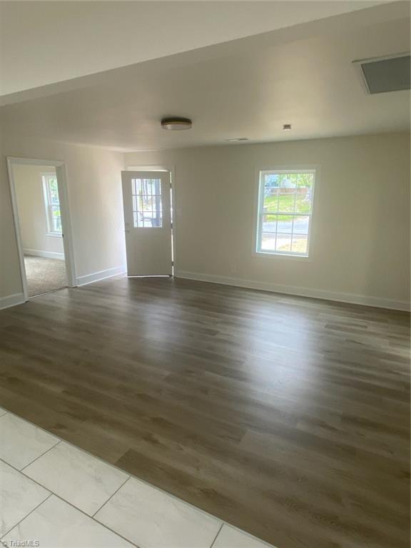 820 Broad Ave, Greensboro, NC 27406 - spare room with baseboards and wood finished floors
